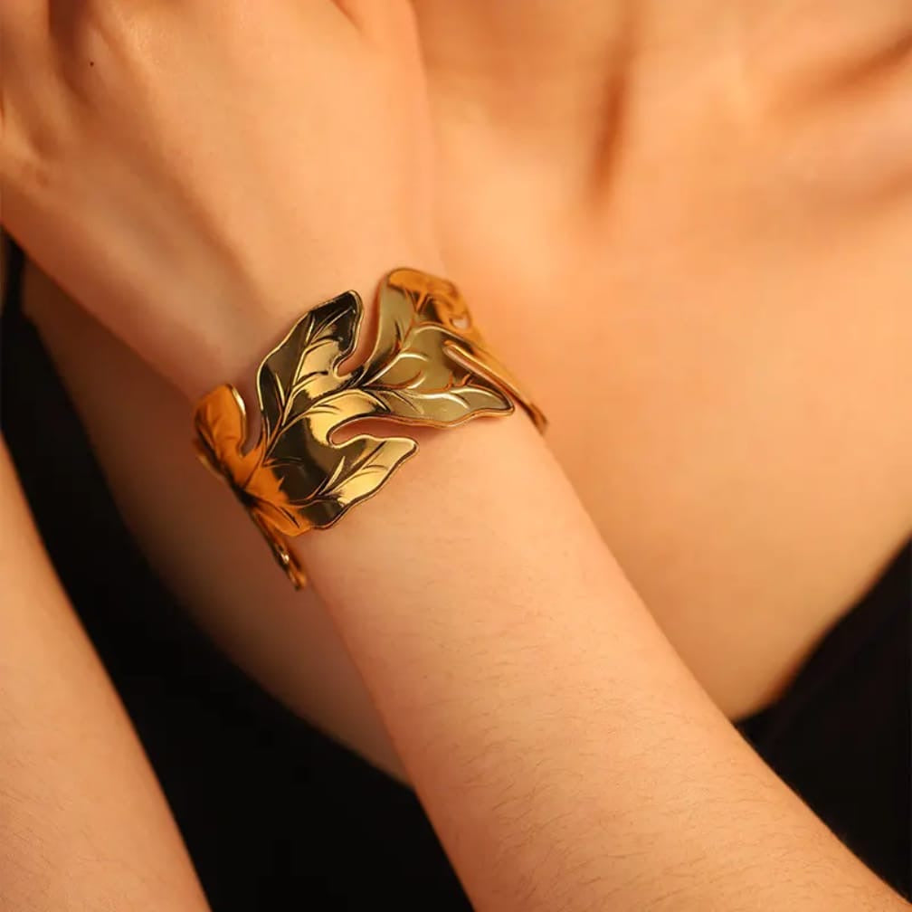 Gold-plated leaf cuff bracelet.