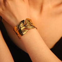 Gold-plated leaf cuff bracelet.