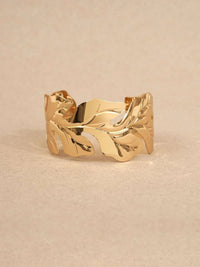 Gold-plated leaf cuff bracelet.